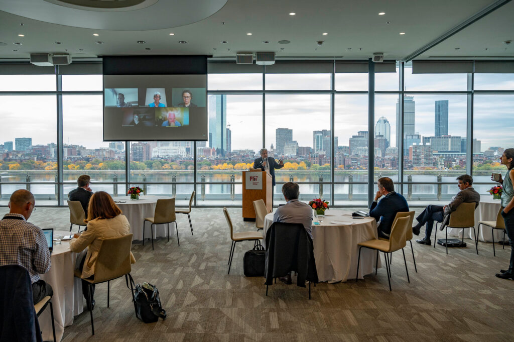 A speaker at a podium addresses symposium attendees